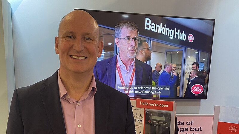 Julian with Banking HUb sign